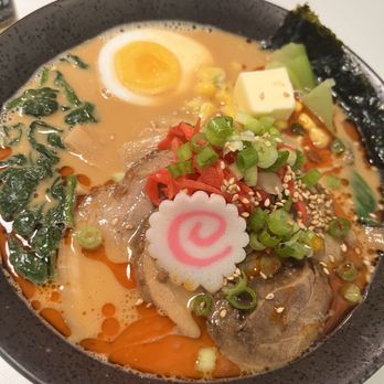 Ultra House - Spicy miso Ramen garnished with Naruto, half an egg, a piece of butter, spinach, green onions, chashu pork, and seaweed - Ramen Near Me - Langley, Washington