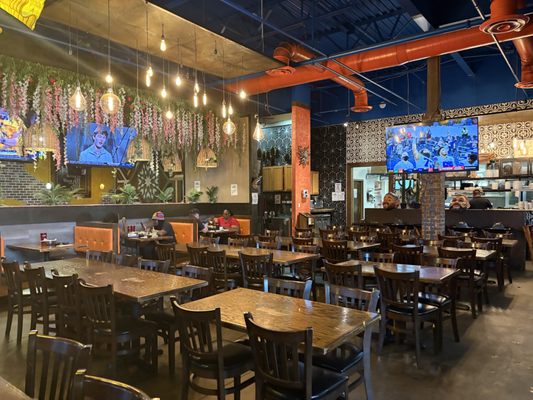 Panoramic view of an Alamo Food Services restaurant at twilight with warm amber glow