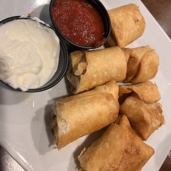 Matthews Diner - Tex Mex Rolls - Fried spring rolls served with side dips of sour cream and salsa on a white plate at Matthews Diner. - Diners Near Me - Waldwick, New Jersey
