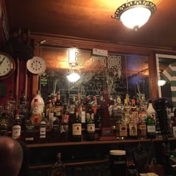 a bar filled with alcohol bottles a bar filled with alcohol bottles