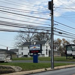 Ophthalmology Physicians & Surgeons, PC - Street view. Signage is located between 2 entranceways. Enter the driveway where the car wash is located. Officers are in the rear.