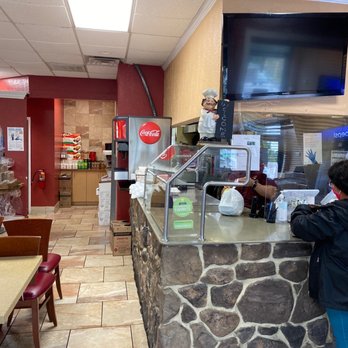 Rincon Italiano - a woman ordering food - Pizza Near Me - Owings Mills, Maryland