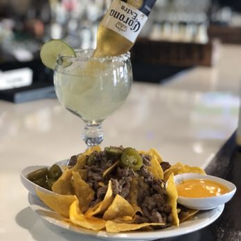 La Esquina Restaurant - a plate of nachos and a bottle of beer - Mexican Near Me - Burien, Washington La Esquina Restaurant - a plate of nachos and a bottle of beer - Mexican Near Me - Burien, Washington