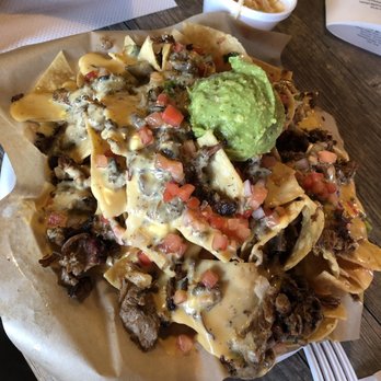 The Pigpen - Brisket Nachos. Large portion. Velveeta-like cheese. - Bars Near Me - San Antonio, Texas The Pigpen - Brisket Nachos. Large portion. Velveeta-like cheese. - Bars Near Me - San Antonio, Texas