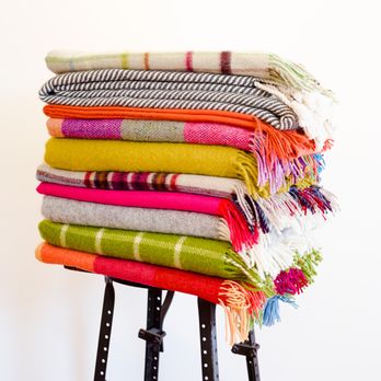 MacKimmie Co - Piles of cozy throws! - Home Decor Near Me - Lenox, Massachusetts