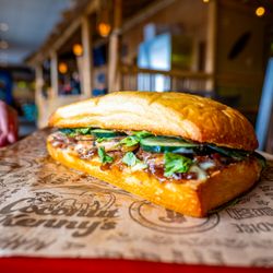 Coconut Kenny's Pizza - Ferndale - Sesame Beef Steak, Mushrooms, Cilantro, Crispy Cucumbers & Topped with a Refreshing Cucumber Wasabi Dressing.