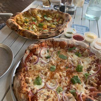 Kai Eats + Drinks - Far pizza is the mango tango and the closest is the BBQ chicken - Tacos Near Me - Kailua-Kona, Hawaii Kai Eats + Drinks - Far pizza is the mango tango and the closest is the BBQ chicken - Tacos Near Me - Kailua-Kona, Hawaii