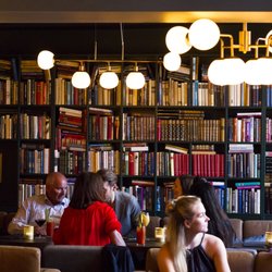 Salong Bar - Wall to wall bookshelf and seating area.
