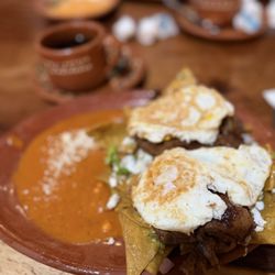 El Puesto Cocina & Lounge - Chilaquiles verdes with added eggs and steak.