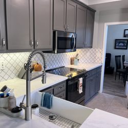 Brawley Construction - Cabinets were refaced and painted. New backsplash and farmhouse sink.