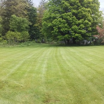 Shortcut Lawn Care - a man mowing the lawn - Landscaping Near Me Shortcut Lawn Care - a man mowing the lawn - Landscaping Near Me
