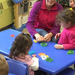Twinkle Little Star Professional Child Care - Ms. Marian with the children