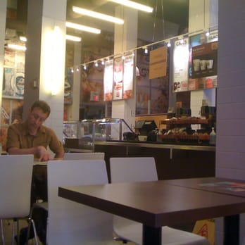 Van Houtte - a man sitting at a table in a restaurant - Coffee & Tea Near Me - Montreal, Quebec
