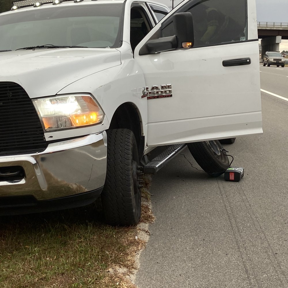 Quick Tripp Roadside Assistance - Owner PJ inflating a tire using the power from his truck and my wife's car tire air pump. I-295 north before exits 21 A-B-C. Fayetteville. - Towing Near Me Quick Tripp Roadside Assistance - Owner PJ inflating a tire using the power from his truck and my wife's car tire air pump. I-295 north before exits 21 A-B-C. Fayetteville. - Towing Near Me