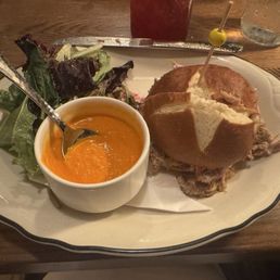 Pulled pork on a pretzel bun with tomato soup