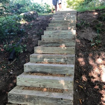 Mountaineer Maintenance - a man walking up a set of stairs - Snow Removal Near Me - Vilas, North Carolina Mountaineer Maintenance - a man walking up a set of stairs - Snow Removal Near Me - Vilas, North Carolina