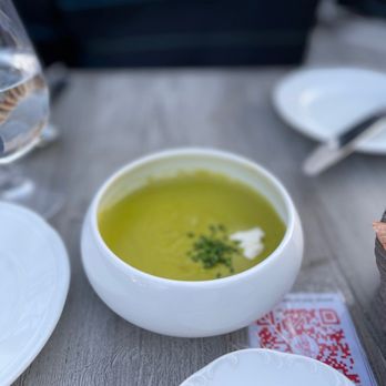 Petit Louis Bistro - a bowl of soup and a slice of cheese - French Near Me - Baltimore, Maryland