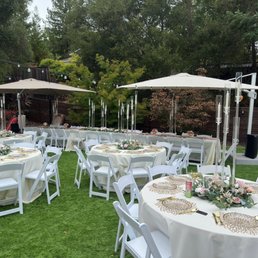 Tables, ivory table cloth and resin chairs Tables, ivory table cloth and resin chairs