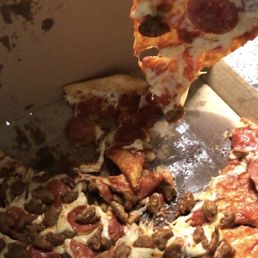 a slice of pizza being taken out of a pizza box a slice of pizza being taken out of a pizza box