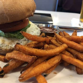 Cat Cora's Kitchen - Burger with over easy egg, and sweet potato fries. Delicious! - New American Near Me - San Francisco, California Cat Cora's Kitchen - Burger with over easy egg, and sweet potato fries. Delicious! - New American Near Me - San Francisco, California