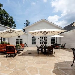 The Sylvia Brafman Mental Health Center - Outdoor patio at The Sylvia Brafman Mental Health Center, with tables, umbrellas, and comfortable seating.