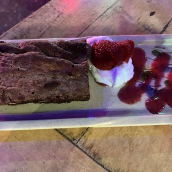 Coya Peruvian Secret - Peruvian Dark chocolate brownie with whipped cream and berry coulis - Peruvian Near Me - Del Mar, California