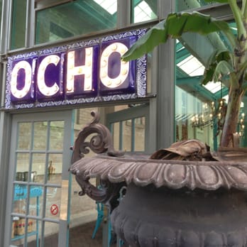 Ocho - Nifty signage between the outdoor patio and the covered patio. - Lounges Near Me - San Antonio, Texas