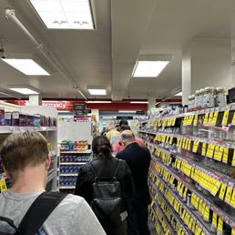 people shopping in a pharmacy store