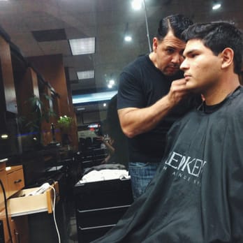 Alexander's Salon and Spa - Oscar doing a cut and style on a client. - Hair Salons Near Me - Brea, California