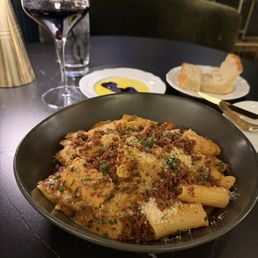 Rigatoni bolognese and complimentary bread with olive oil and balsamic vinegarette. Rigatoni bolognese and complimentary bread with olive oil and balsamic vinegarette.