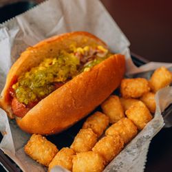 Bacon wrapped L.A. style street dogs - w/ grilled onions and topped off with your favorite condiments. Served with a side of fries or tots.