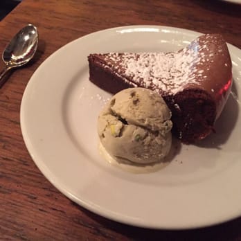 Pepe Giallo - Flourless chocolate cake with pistachio ice cream. - Italian Near Me - New York, New York Pepe Giallo - Flourless chocolate cake with pistachio ice cream. - Italian Near Me - New York, New York