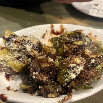 Grafton Tavern - a plate of brussel sprouts on a table - American Near Me - Carleton, Michigan