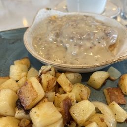 Turkey gravy over a biscuit, potatoes, and eggs