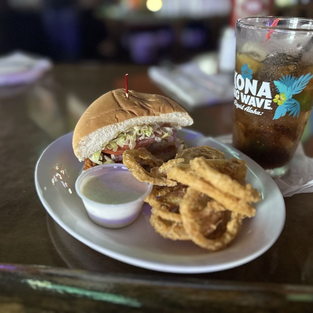 Time Out Tavern - Half of a buffalo chicken sandwich and onion rings - Sports Bars Near Me - Humble, Texas Time Out Tavern - Half of a buffalo chicken sandwich and onion rings - Sports Bars Near Me - Humble, Texas