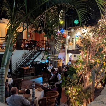 Santo Cielo - Looking down into the courtyard from the street. The upper level seating can be seen to the left. - Steakhouses Near Me - Loreto, BCS Santo Cielo - Looking down into the courtyard from the street. The upper level seating can be seen to the left. - Steakhouses Near Me - Loreto, BCS