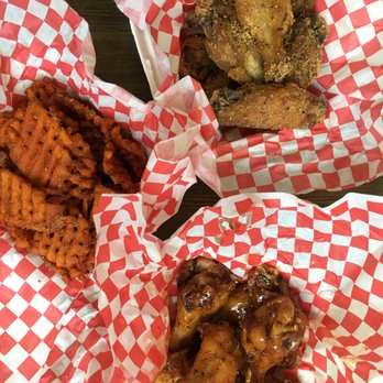 Heavenly Buffaloes - Garlic Parmesan (top), sweet Thai Chili coconut (bottom), and a half order of lemon pepper sweet potato waffle fries. All delicious! - Chicken Wings Near Me - Durham, North Carolina Heavenly Buffaloes - Garlic Parmesan (top), sweet Thai Chili coconut (bottom), and a half order of lemon pepper sweet potato waffle fries. All delicious! - Chicken Wings Near Me - Durham, North Carolina