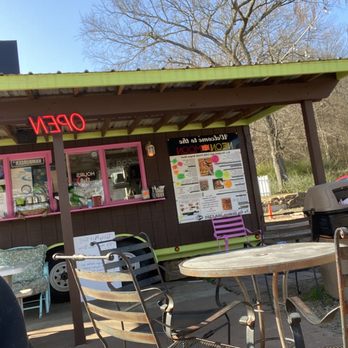 Neon Moon - the outside of a restaurant with tables and chairs - Burgers Near Me - Mountainburg, Arkansas