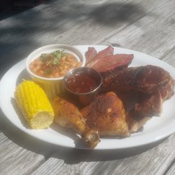 Now That's BBQ - Chicken, Brisket, and Rib combo plate with corn on the cob and baked beans.