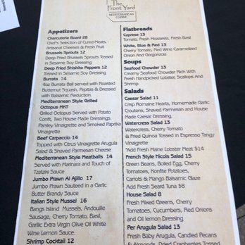 The Front Yard - The menu from The Front Yard Mediterranean Cuisine includes sections for appetizers, flatbreads, soups, salads, and house salads. Items listed are charcuterie, bruschetta, deep-fried Brussels sprouts, seafood chowder, Caesar salad, and Mediterranean-style meatballs. Prices range from $12 to $17. The menu is printed on a beige background with black text and a logo at the top. - Mediterranean Near Me - Ogunquit, Maine