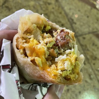 Roberto’s Taco Shop - a hand holding a burrito - Mexican Near Me - Sparks, Nevada