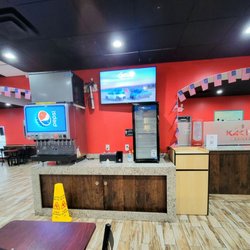 Kachi's Chicken - The doorway on the left leads to a dining room. Self-serve drink machine on the left. The front doors are on the right, off camera.