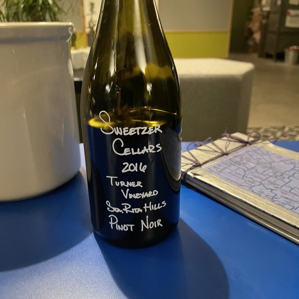Sweetzer Cellars - a bottle of wine on a table - Wine Tasting Room Near Me - Lompoc, California Sweetzer Cellars - a bottle of wine on a table - Wine Tasting Room Near Me - Lompoc, California