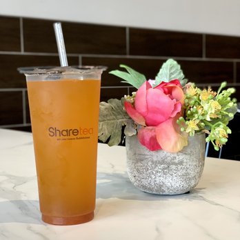 Sharetea - a glass of iced tea next to a vase of flowers - Coffee & Tea Near Me - Plano, Texas Sharetea - a glass of iced tea next to a vase of flowers - Coffee & Tea Near Me - Plano, Texas