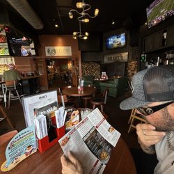 Drake's - My man looking at the menu. Hmmm sushi or a burger