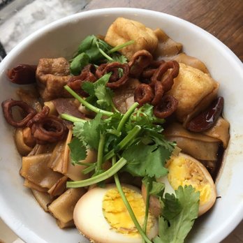 Kopitiam - A photo of the special that went on the day I went! Flat noodles, boiled marinated egg, tofu, pork belly, cilantro, in a light soy broth. - Malaysian Near Me - New York, New York