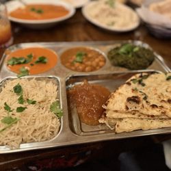 Maruti Indian Restaurant - Left Tikka Masala, right Palek Paneer, the middle I think is Chana Masala. With mango chutney, rice and garlic naan.