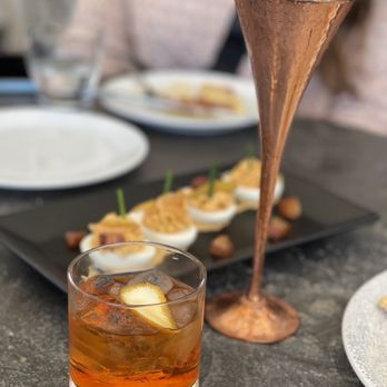 A'Bouzy - a glass of tea and a plate of food - Champagne Bars Near Me - Houston, Texas A'Bouzy - a glass of tea and a plate of food - Champagne Bars Near Me - Houston, Texas
