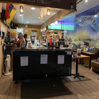 Arepas Cafe - a woman standing in front of the counter - Venezuelan Near Me - Astoria, New York