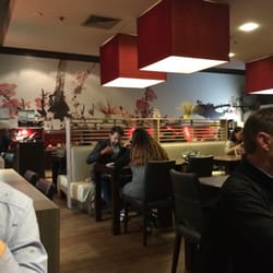 Umi Japanese Restaurant - Interior has giant red lanterns, calligraphy art on one wall and Japanese ornaments on the other.